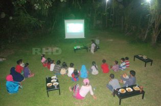 RHD. Kelas Komunitas, orang tua, dan warga nonton bersama film Le Temps d'un Échange di pelataran Mappasomba, Rumah Hijau Denassa (RHD).
